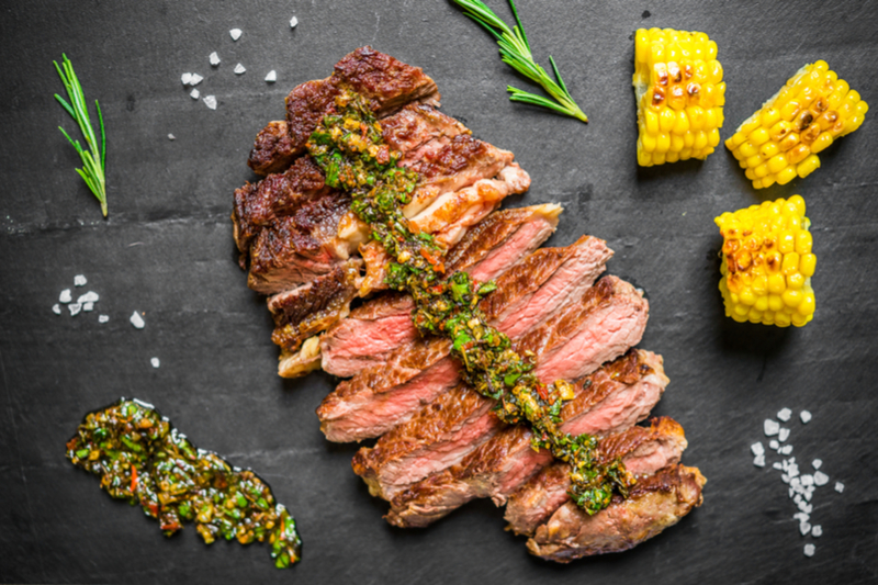 chimichurri on grilled meat, grilled corn on the cob