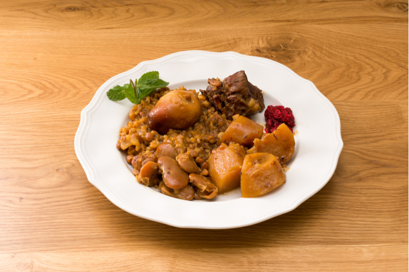 Plate of cholent with garnish