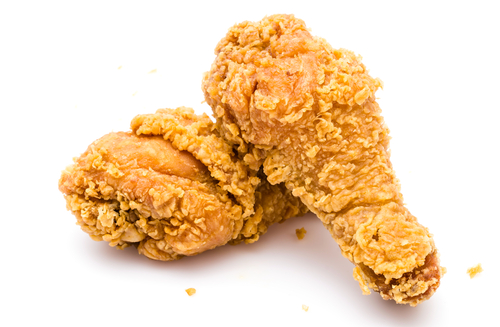 Southern fried chicken drumsticks against white background
