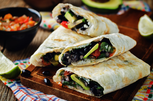 black beans and rice with avocado in a burrito