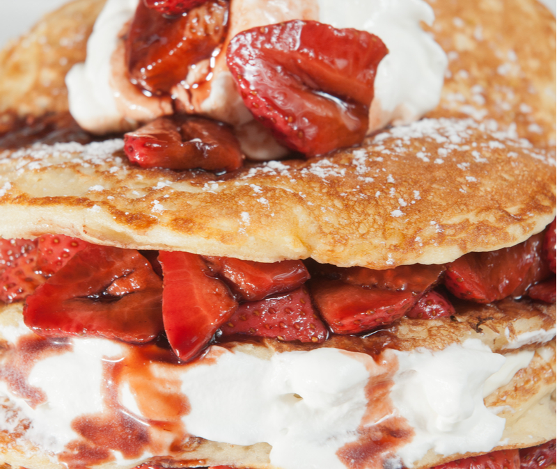 roasted strawberries on pancakes with whipped cream