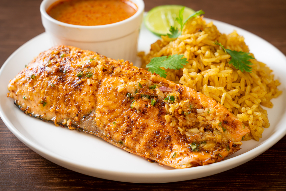 zesty chili lime salmon fillet plated with yellow rice